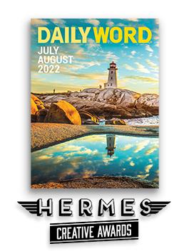 The cover of July/August 2022 Daily Word with an image of a lighthouse in a cloud-filled sky at sunset with the Hermes Creative Awards logo