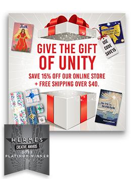 An open present with the text "Give the Gift of Unity - Save 15% off our online store + free shipping over $40" surrounded by Unity holiday products with a Platinum 2023 Hermes Award