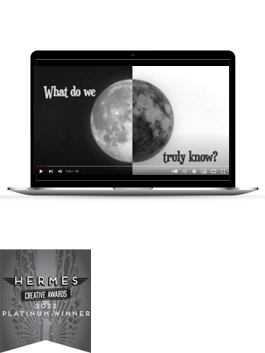 A still from "Perfect Vision: Seeing Through a Spiritual Lens" - Half of the moon is black on a white screen and the other half is white on a black screen with the text "What do we truly know?" - on a black laptop with a Platinum 2022 Hermes Award